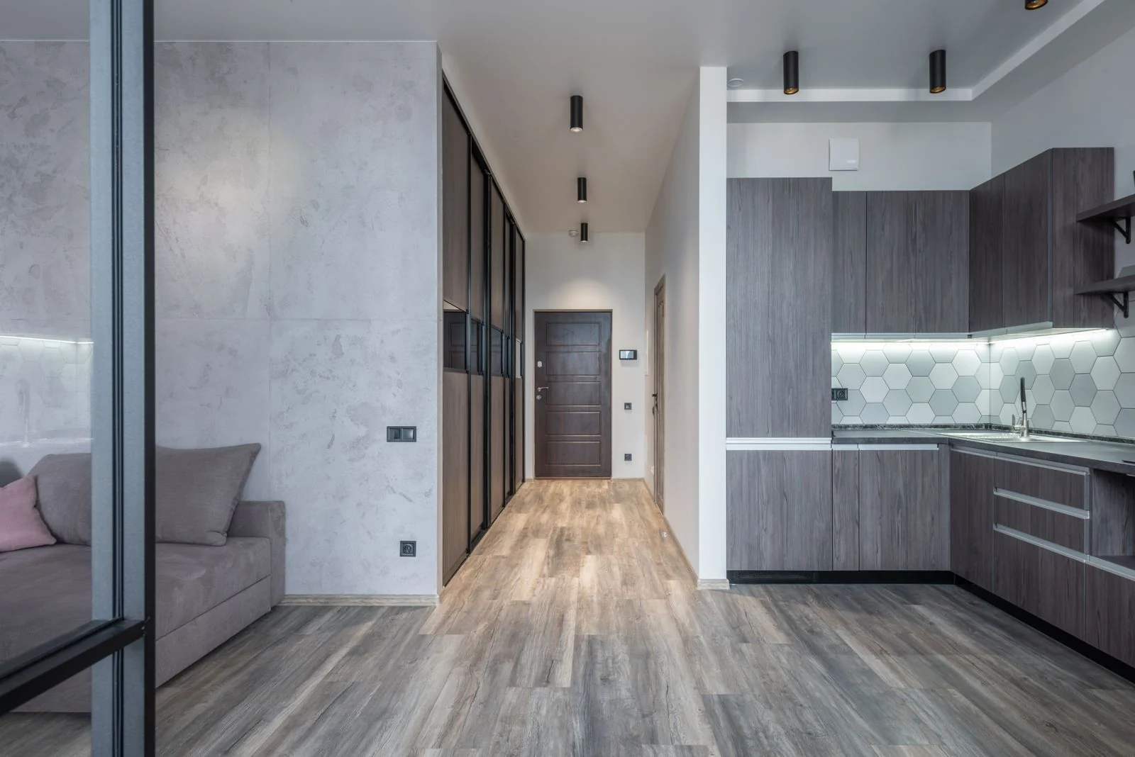 Modern open kitchen with a gray wood look plank floor