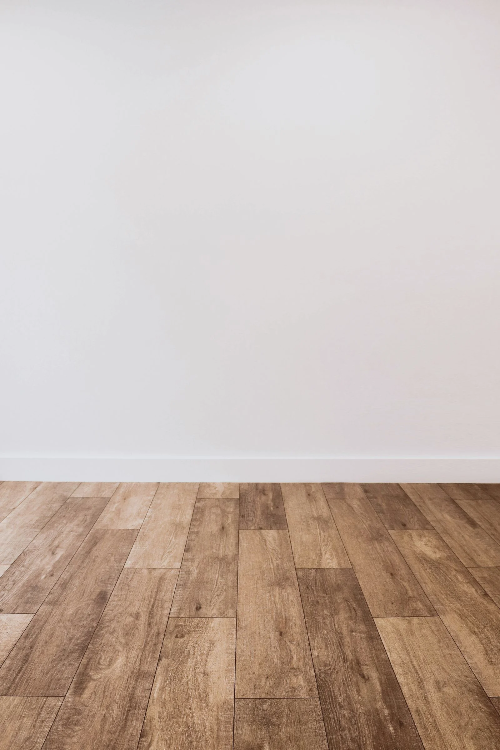 Rustic medium plank with visible knots against a white wall